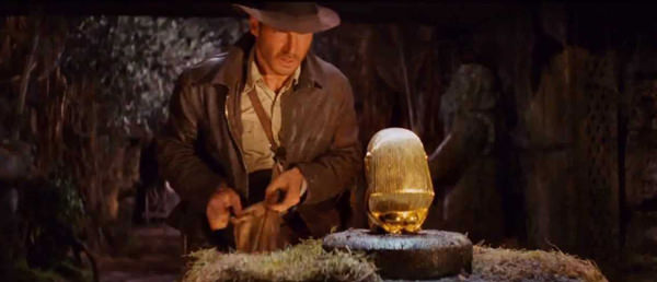 indiana jones looking at gold statue