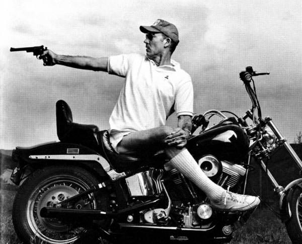 hunter s thompson on a bike shoting a gun