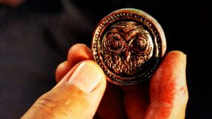 Daniel holding a mysterious coin
