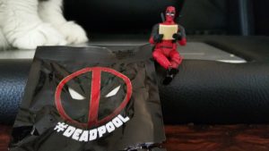 Deadpool posing with paper
