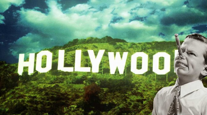 kid with clothespin on his nose in front of the hollywood sign