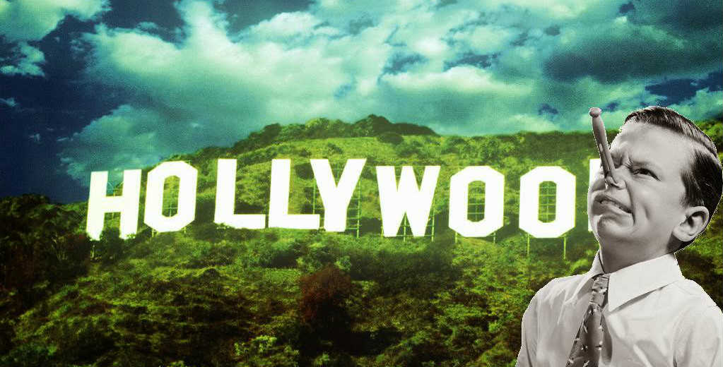 kid with clothespin on his nose in front of the hollywood sign