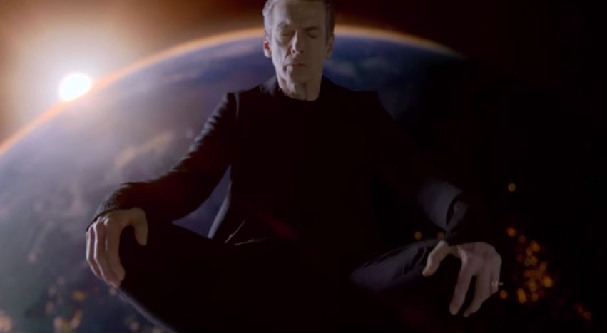 the doctor sitting on top of his tardis