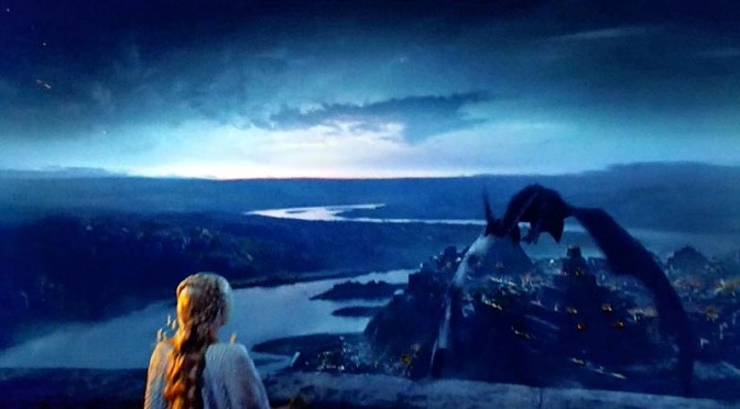 mother of dragons looking at a dragon