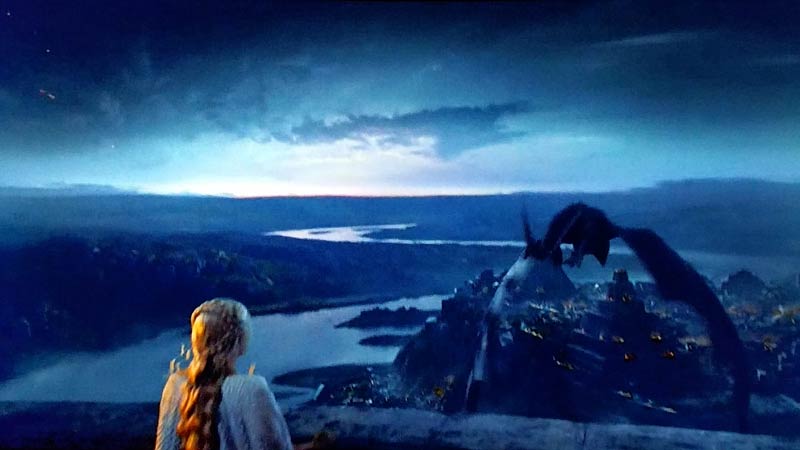 mother of dragons looking at a dragon