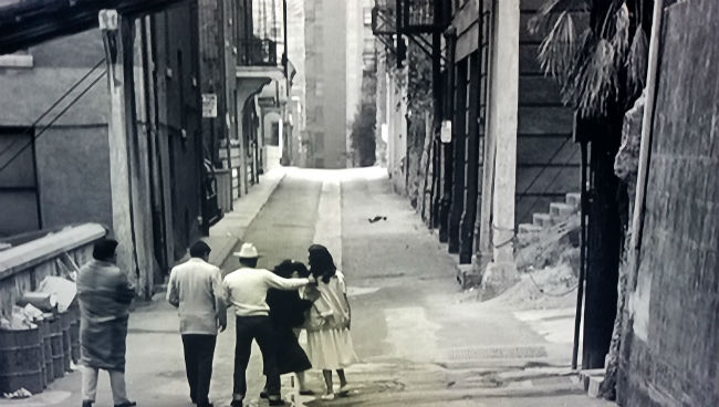 Homer and Tommy walking down a street