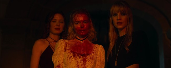 Mina, Lucy, and Nora stand over Hap's bleeding body