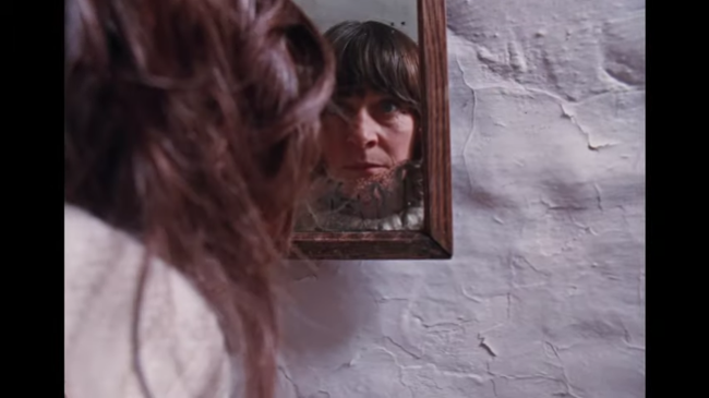 Mary Woodvine stares at herself in a mirror