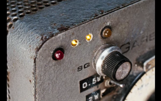 A close up of a two way radio dial in Enys Men.