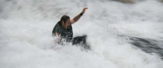 Burt Reynolds falls down the rapids.
