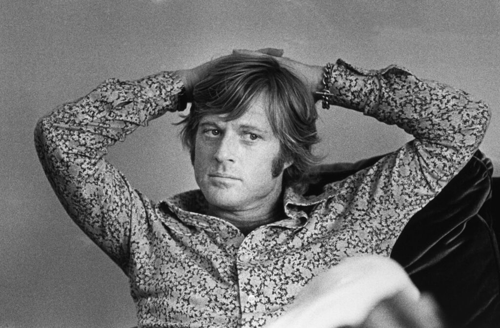 Robert Redford leans back in 1972